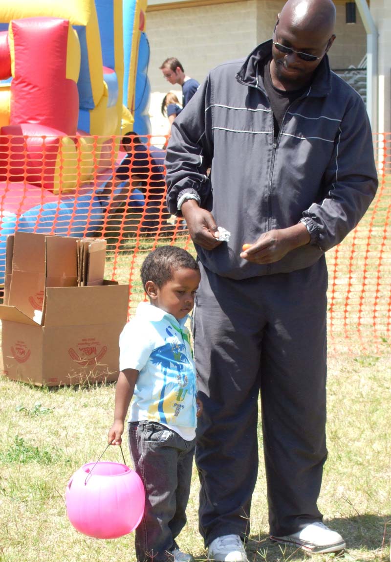 photo of kid and parent hunting for eggs